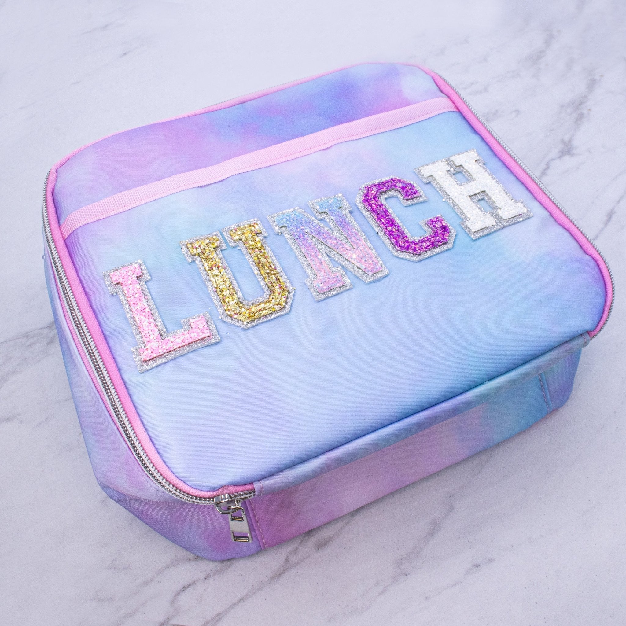 https://frogsac.com/cdn/shop/products/tie-dye-lunch-box-with-glitter-varsity-letter-patches-lunch-583084.jpg?v=1687884000